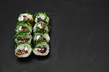 Sushi rolls with seafood and Chuka salad. Green sushi. Free space for your text.