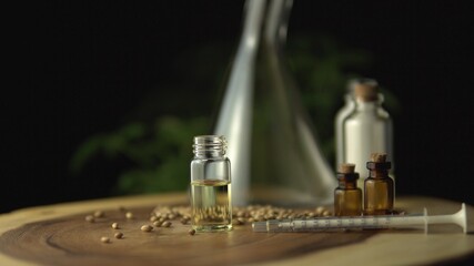 CBD oil extracted from a marijuana plant in the syringe and little glass jar bottle. Modern healthcare pharmacy concept. Legalization of medical cannabis hemp plants.