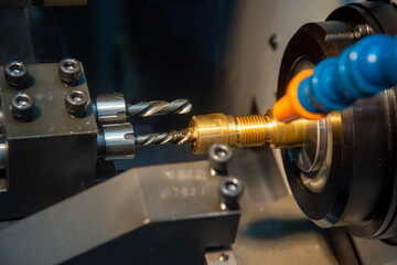 The  multi-tasking CNC lathe machine swiss type drilling at the brass  shaft . The hi-technology metal working process with turning machine control by CNC program