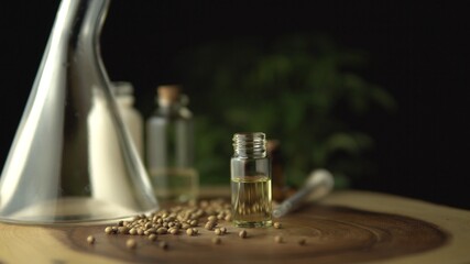 Very close view of CBD oil, oral syringe, pills for anxiety and stress relief near the glass jar on the wood circle tree ring table with ripple line pattern. Revolution in pain treatment and healing.
