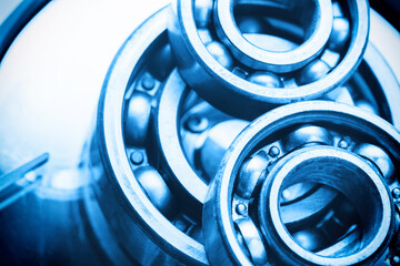 Machinery and technology background. Group of various ball bearings on hard disk drive. - obrazy, fototapety, plakaty