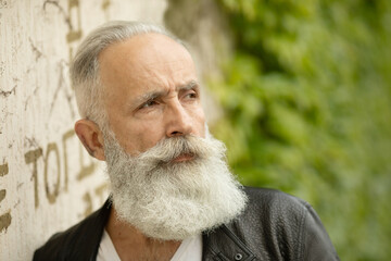 Attractive bearded senior model man in urban context.