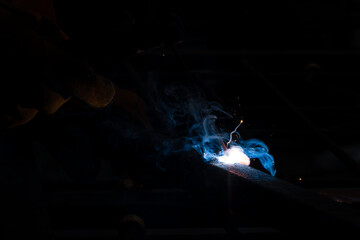 Welder worker welding steel by electric welding and protect yourself with leather gloves.