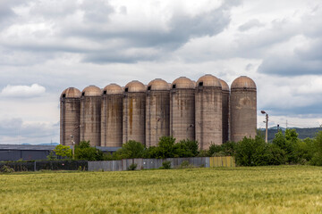 Grain silos in a wheat field.