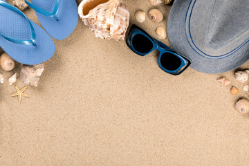 Fototapeta na wymiar Beach accessories on the sand background.Summer vacation concept.Travel mood to the sea.