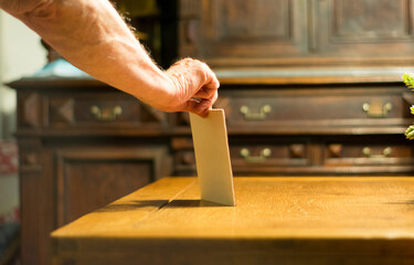 Hand showing a paper on a table. 