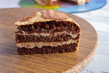 Slice of gluten free chocolate cake on kitchen board