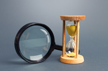 Magnifying glass and hourglass. Limited Search Concept. Find free time. Subscription, paid plan....