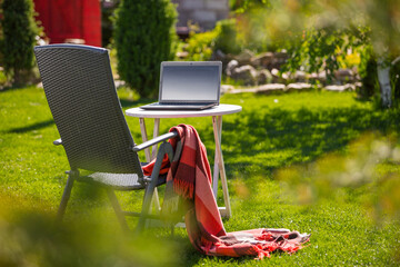 Working, studing in one's own garden with online lessons, staying home due to quarantine. Nature office concept