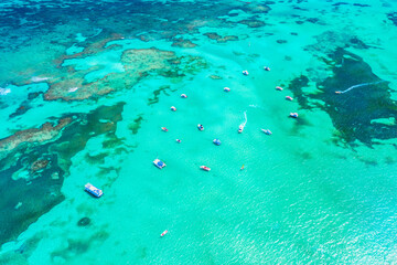 Fototapeta na wymiar Aerial view of tropical caribbean sea with yachts and boats on blue turquoise ocean. Dominican Republic