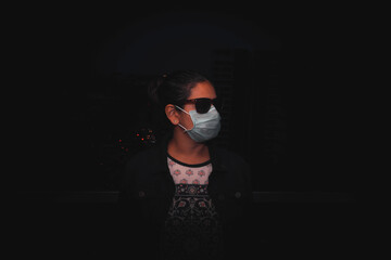 Young woman wearing surgical mask during the pandemic situation.