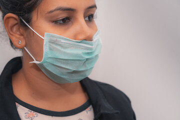 Young woman wearing surgical mask during the pandemic situation.