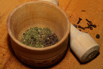 wooden mortar and pestle with herbs