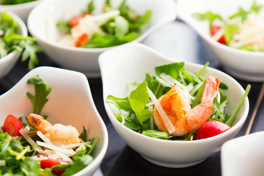 Tasty salad plates with shrimps. Close up image with selective focus.