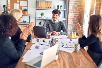 Group of business workers smiling happy and confident. Working together with smile on face applauding one of them at the office