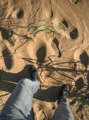 a man walks on the sand