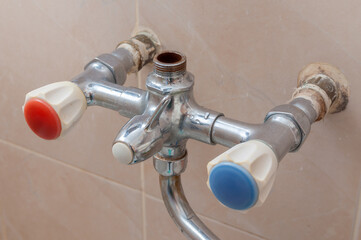 broken faucet in the bathroom from which the water flows.