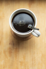 Fototapeta na wymiar Cup of coffe on the wooden kitchen board.