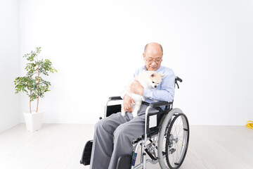 犬を飼う車椅子に乗った高齢の男性