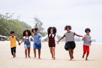 Funny vacation. Children or kids playing and romp together at the beach on holiday. Having fun after unlocking down the city from COVID19. Seven African American kids. Ethnically diverse concept