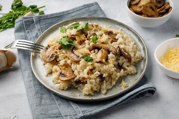 A dish of Italian cuisine - risotto from rice and mushrooms.