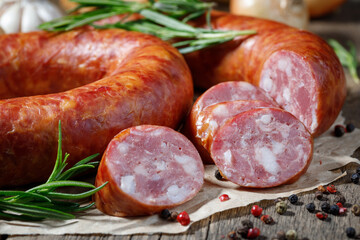 Smoked sausage on a wooden table. Rustic style.