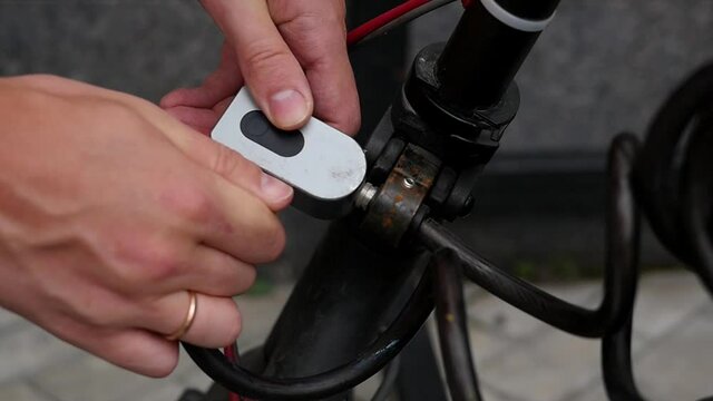 Closeup locks a bicycle lock in a parking lot. Theft Prevention, Lock