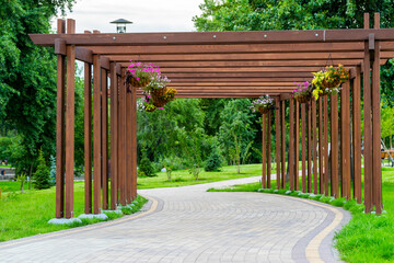 wooden garden arch with landscaping and garden street flowers and plants