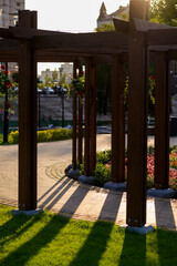 landscaping using a wooden arch in the garden with flowers and plants, a flowerbed with bright flowers planted according to the pattern