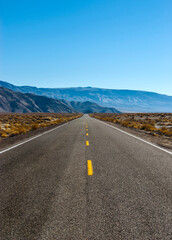 The road intersects the plain and rests against the mountains.