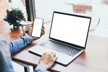 computer,cell phone mockup image.hand woman work using laptop texting mobile.blank screen with white background for advertising,contact business search information on desk in cafe.marketing,design