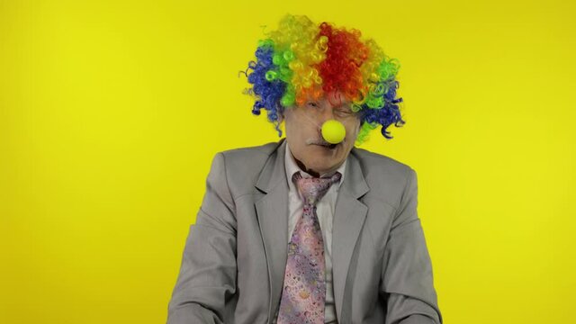 Senior clown businessman entrepreneur boss making silly faces. Expressions