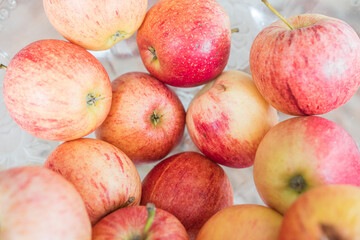 Beautiful fresh & organic colorful apples picked from the garden in a salad bowl. Big close up from above.