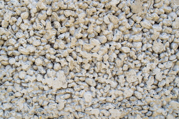 Texture of a wall covered with rubble stone, abstract background, stock photo