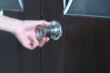 A girl open doorknob to the house
