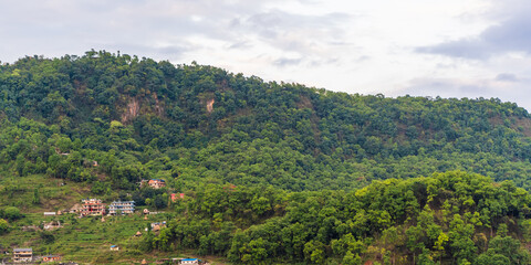 Hills of Nepal, covered with jungle. Landscape with tropical rainforest in bright summer day. Reference image for CG drawing, matte painting. Stock photo.