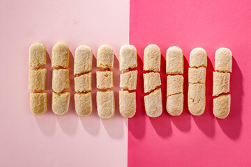 Aerial view of sweet cakes on a pink background