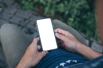 cell phone mockup image blank white screen.man hand holding texting using mobile on desk at coffee shop.background empty space for advertise.work people contact marketing business,technology