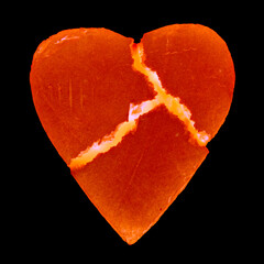 Broken scratched heart burning inside. Isolated on black background
