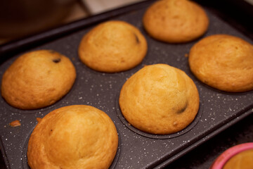 Homemade cupcakes with iron mold lie on a wooden plate