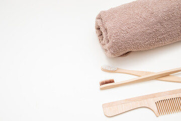 Fototapeta na wymiar Bath and home accessories. Towel, bamboo toothbrush and comb. Zero waste. Beauty and SPA concept. Free space