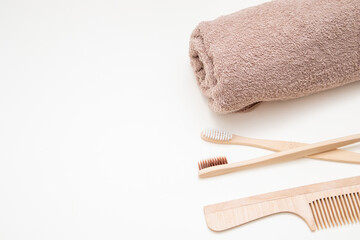 Bath and home accessories. Towel, bamboo toothbrush and comb. Zero waste. Beauty and SPA concept. Free space