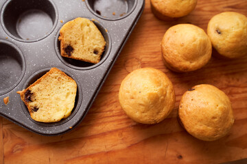Homemade cupcakes with iron mold lie on a wooden plate
