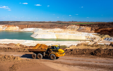 Big truck works at quartz sand quarry