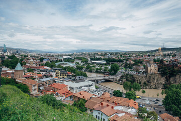Fototapeta na wymiar Panoramic view of the city of Tbilisi from the Narikala fortress, the old city and modern architecture. Tbilisi is the capital of Georgia