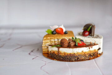 three quarters of delicious bright cakes on the table layered, chocolate decorated with fresh berries