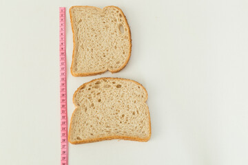 Measure diet healthy bread on the white background.