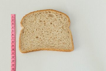 Measure diet healthy bread on the white background.