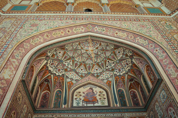 the ceiling of the gate is painted with an ornament in yellow tones, India