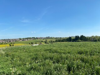 Fields and meadows, with houses on the horizon near Bradford, Yorkshire, UK